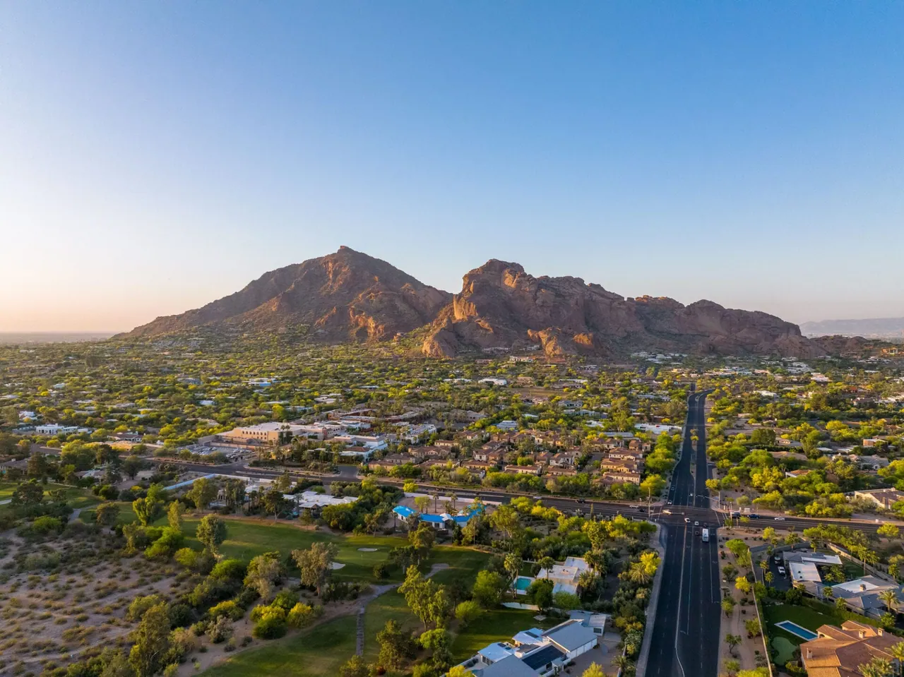 Aerial view of Camelback Mountain and Phoenix neighborhoods at sunset